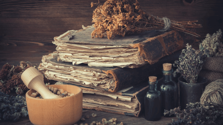 Vintage books, glass medicine bottles, and dried herbs representing the historical use of plant-based medicine
